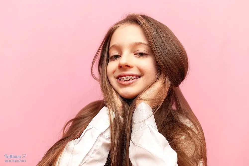 girl with metal braces posing at the camera after understanding how long do braces take in greenville, sc
