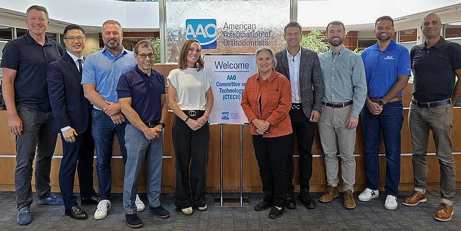 Eleven people, including Dr. Blake Tollison of Tollison Orthodontics in Greenville, SC, stand by an AAO CTECH welcome sign indoors.