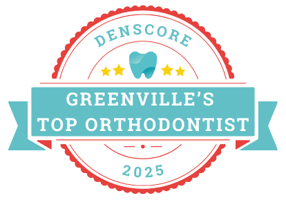Circular badge reading "Denscore, Greenville's Top Orthodontist 2025," featuring a tooth icon and stars, set against a teal banner, celebrating excellence in orthodontics.